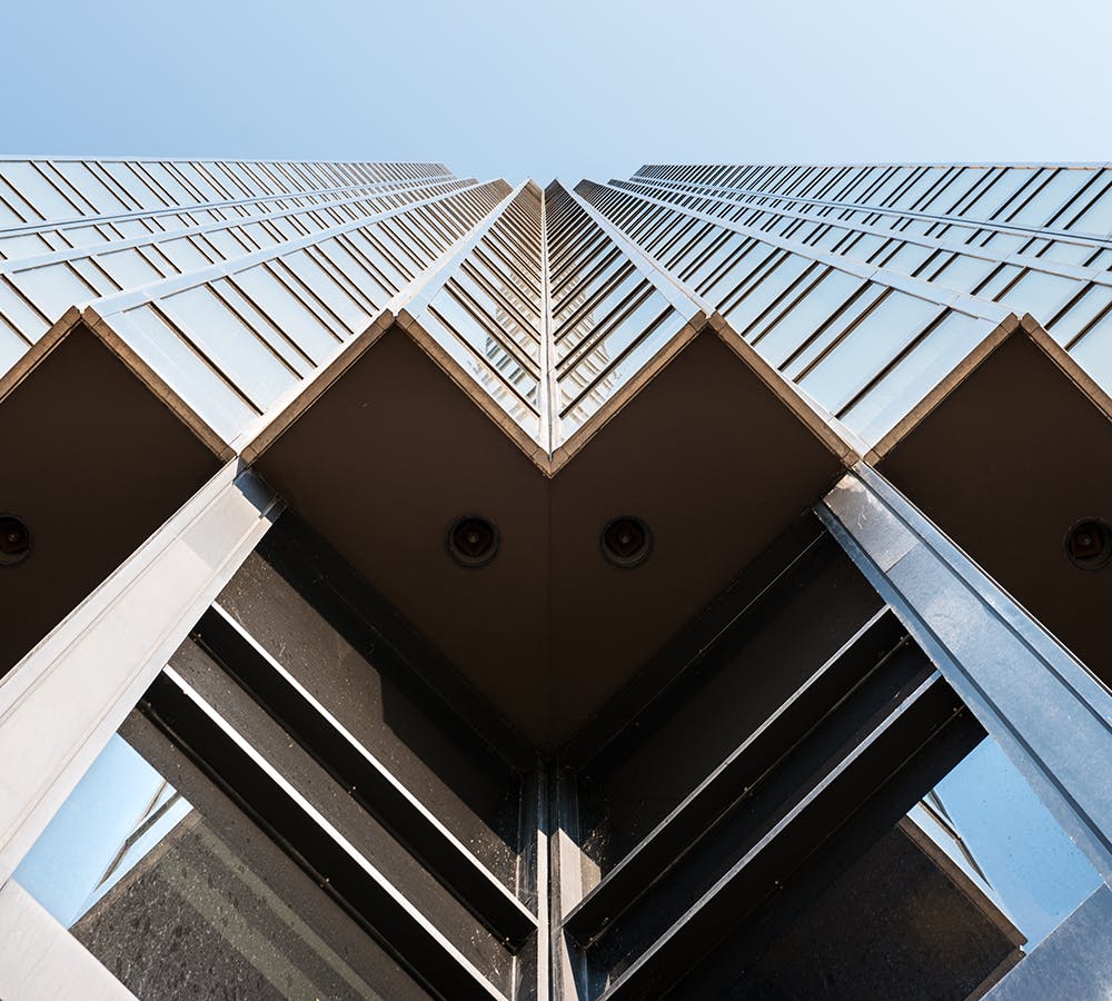 A photo of a skyscraper from below looking up.